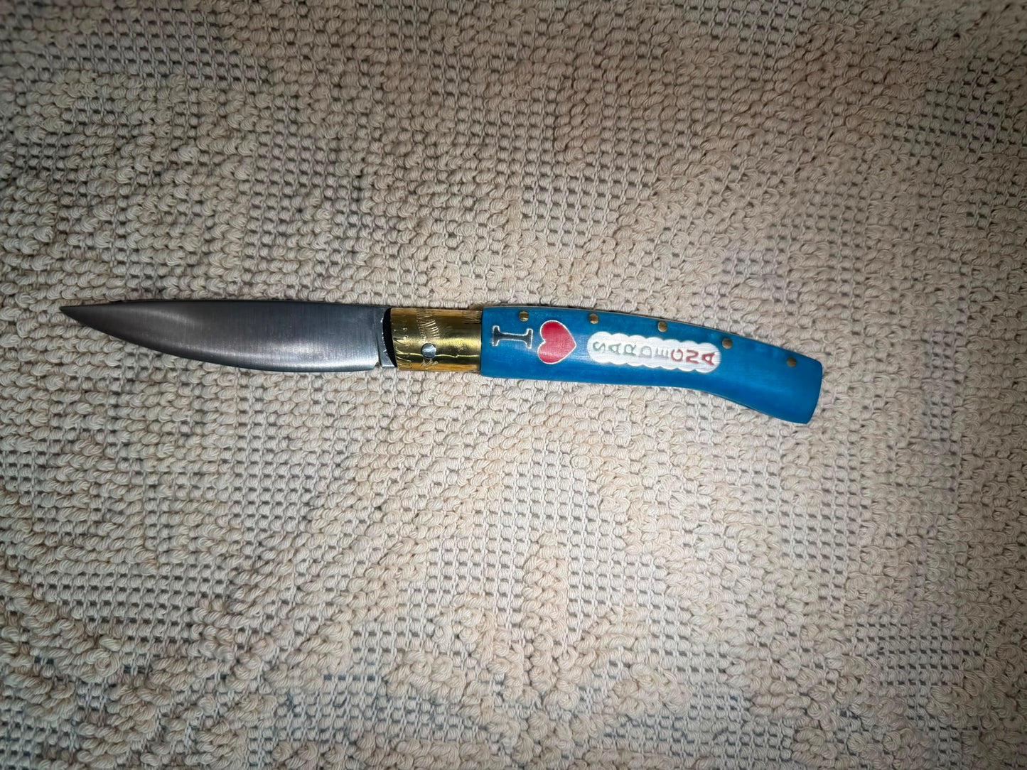 Coltello  pattadese con anima  , lama 10,5 CM  impugnatura in resina colore oceano,con scritta I love Sardegna.
